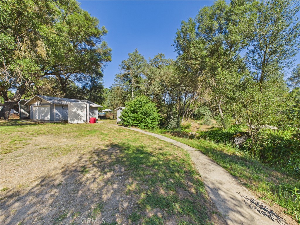 4208 Ramsden Road Mariposa, CA 95338 - Photo 39 of 42 a white house with a yard plants and large trees