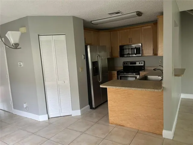 a kitchen with stainless steel appliances a refrigerator and a stove