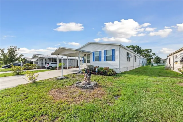 a view of a house with backyard and porch