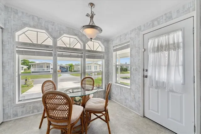 a dining room with furniture a chandelier and wooden floor