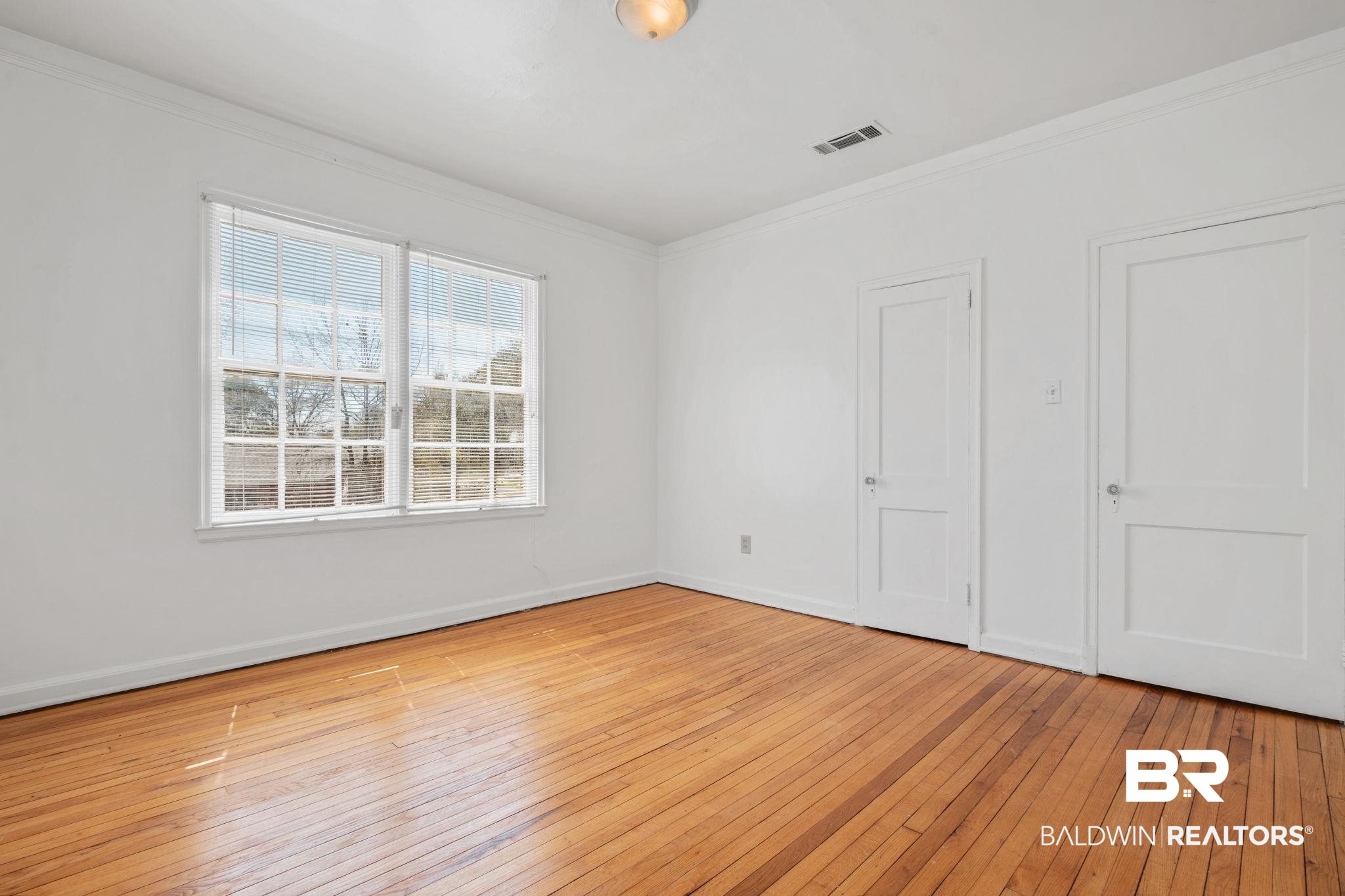 1707 Church Street Mobile, AL 36604 - Photo 32 of 43 Unfurnished bedroom with light wood-style flooring, baseboards, and ornamental molding