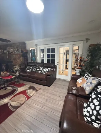 a living room with furniture and a floor to ceiling window