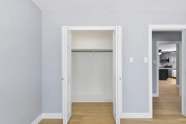 a view of a hallway with wooden floor