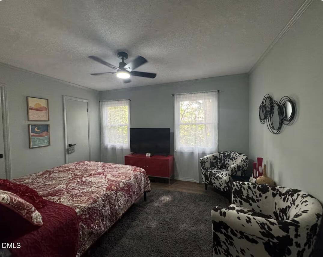 6369 New Market Way Raleigh, NC 27615 - Photo 7 of 14 a bedroom with a bed and a chandelier