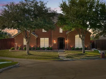a brick building with trees in the background