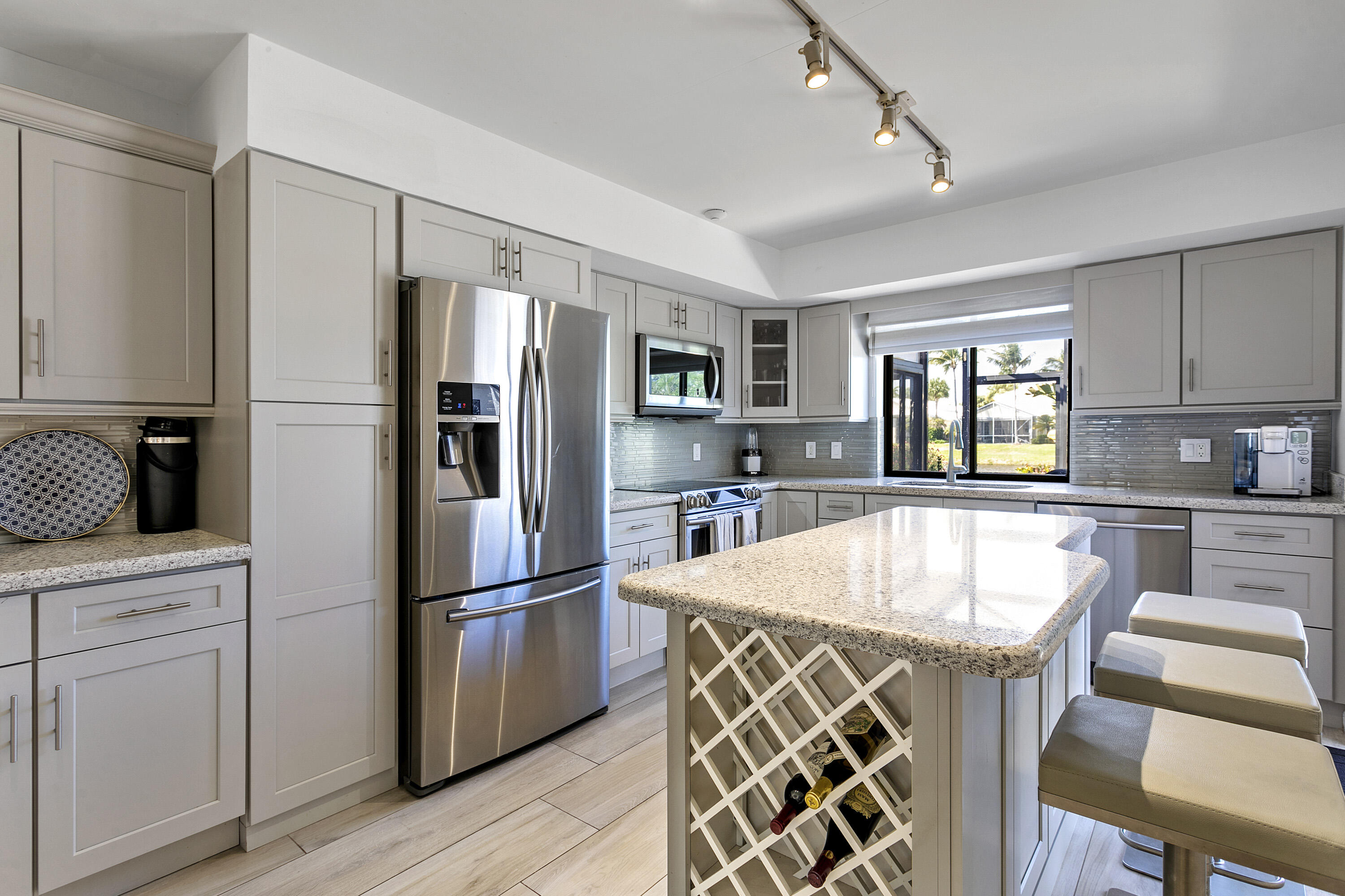 3697 Cape Pointe Circle Jupiter, FL 33477 - Photo 13 of 55 a kitchen with stainless steel appliances granite countertop a refrigerator and a stove top oven