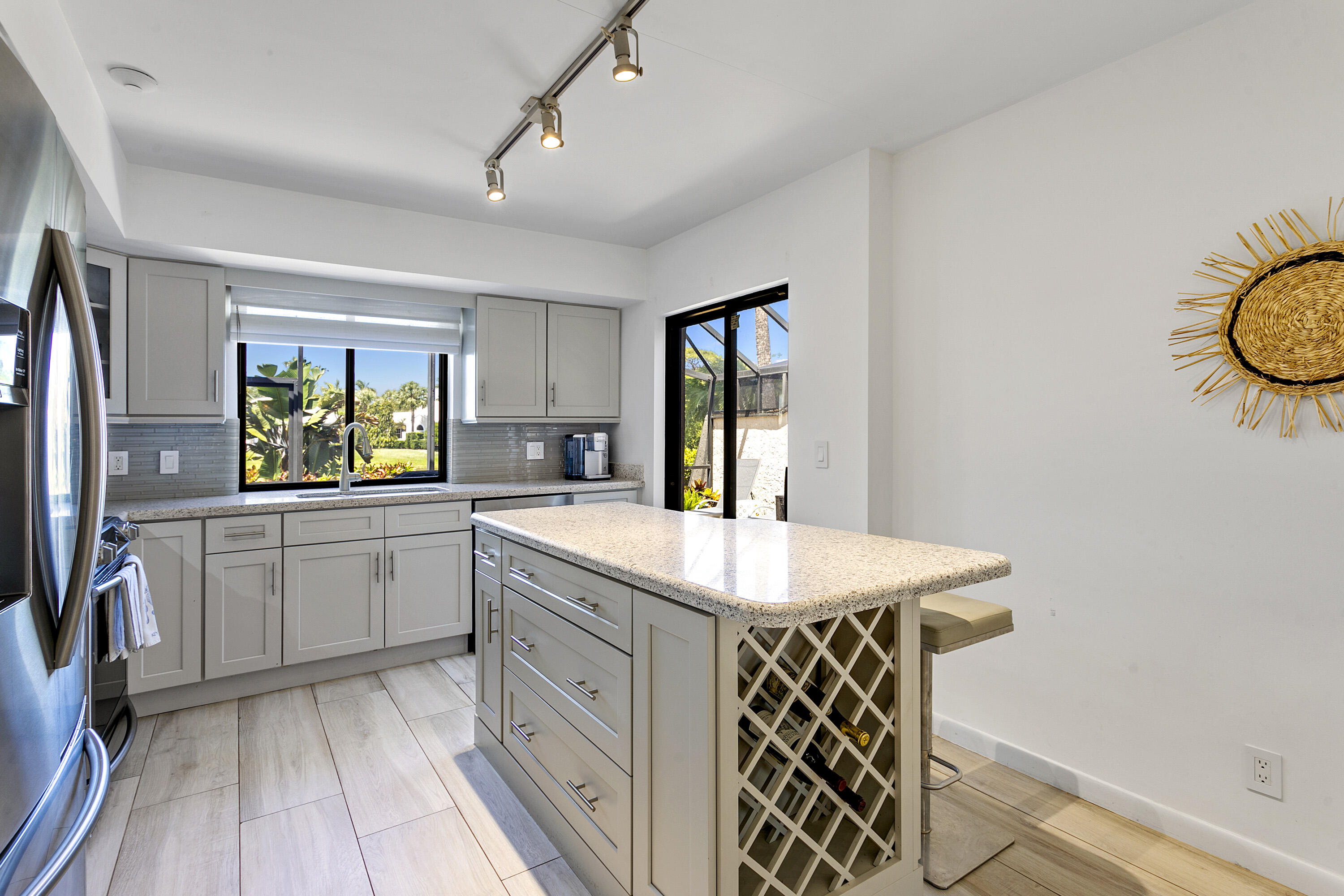 3697 Cape Pointe Circle Jupiter, FL 33477 - Photo 14 of 55 a kitchen with a sink stove and refrigerator