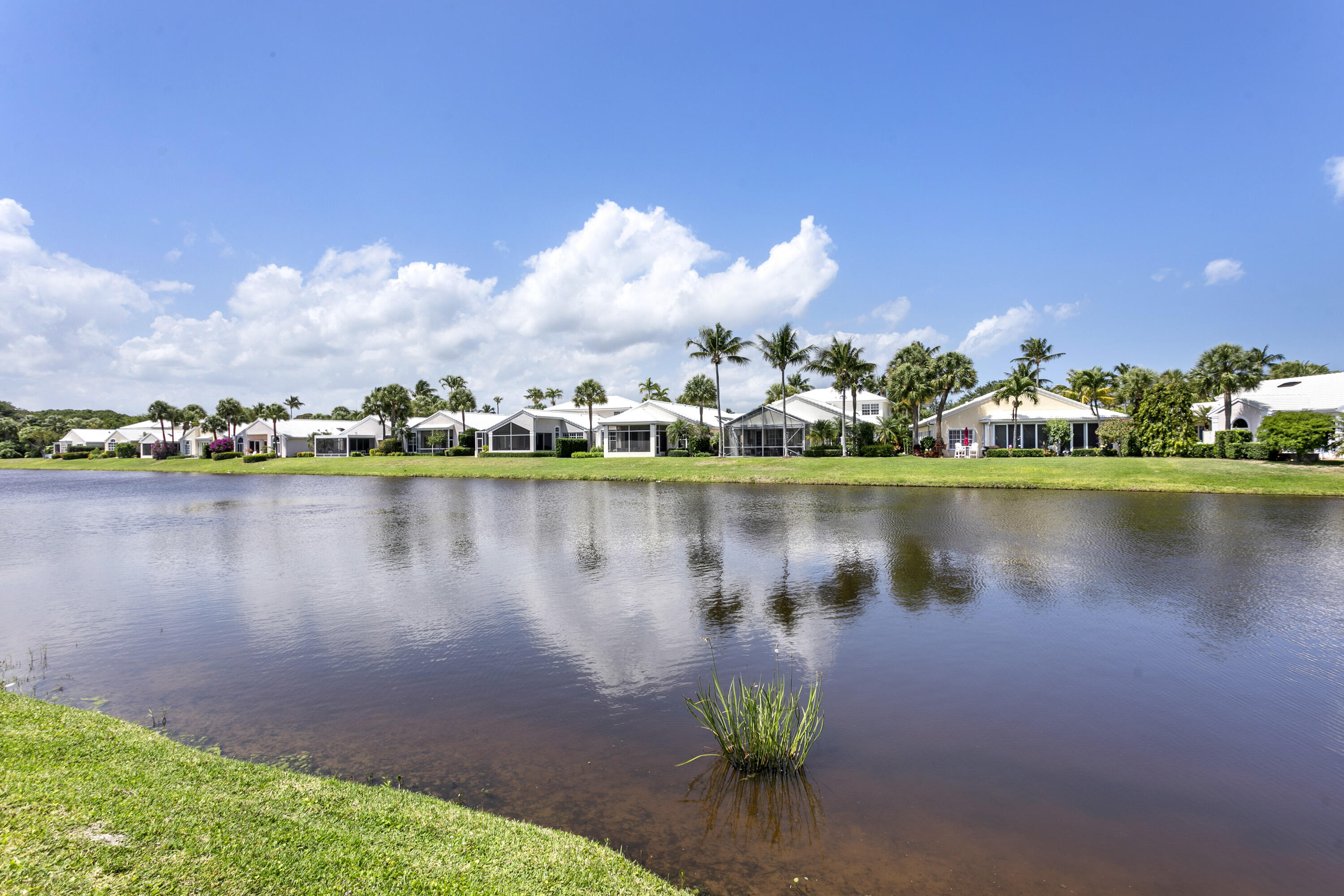 3697 Cape Pointe Circle Jupiter, FL 33477 - Photo 19 of 55 a view of a lake with a house in the background