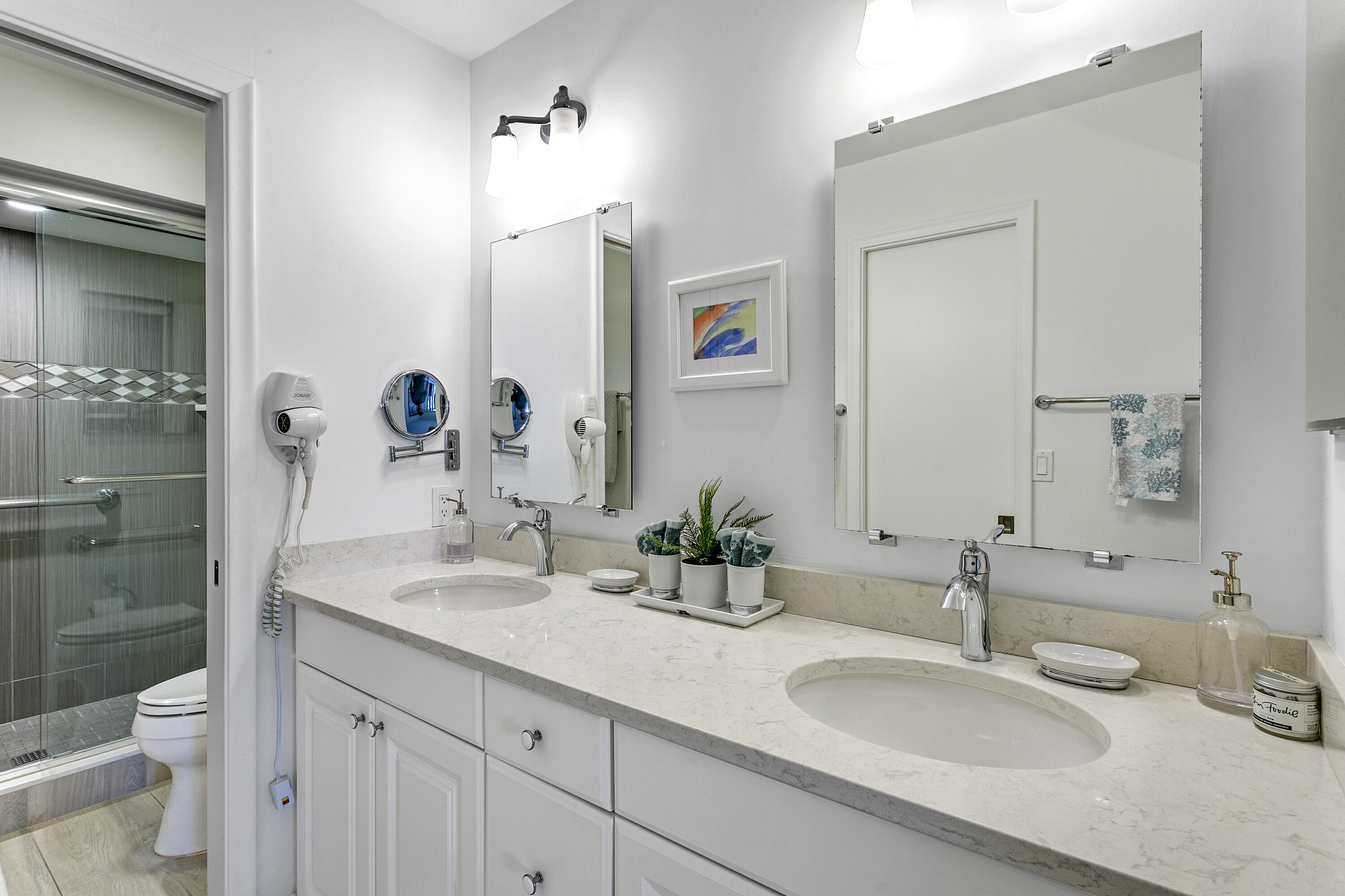 3697 Cape Pointe Circle Jupiter, FL 33477 - Photo 22 of 55 a bathroom with a granite countertop sink a toilet and a mirror