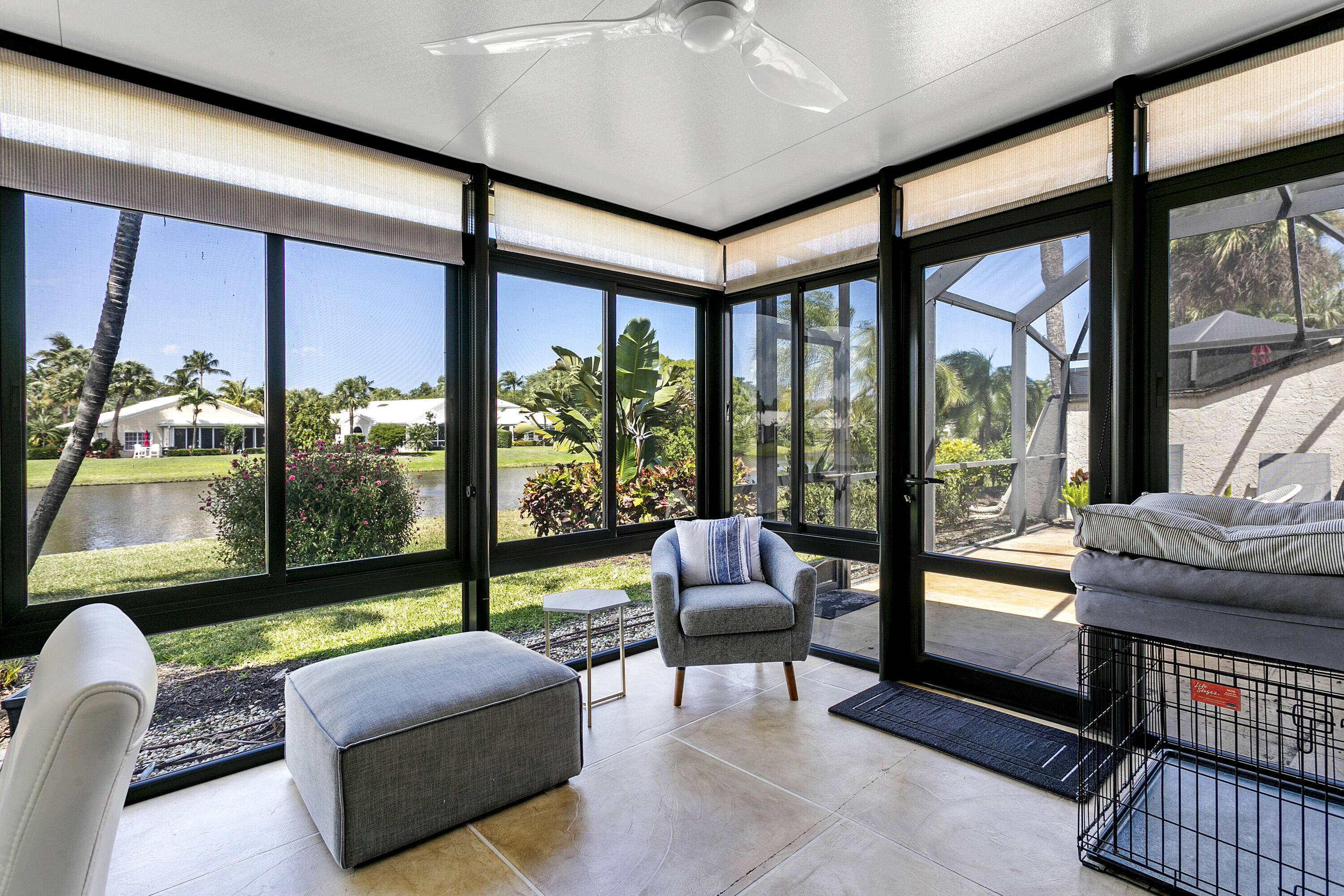 3697 Cape Pointe Circle Jupiter, FL 33477 - Photo 25 of 55 a living room with furniture and a floor to ceiling window