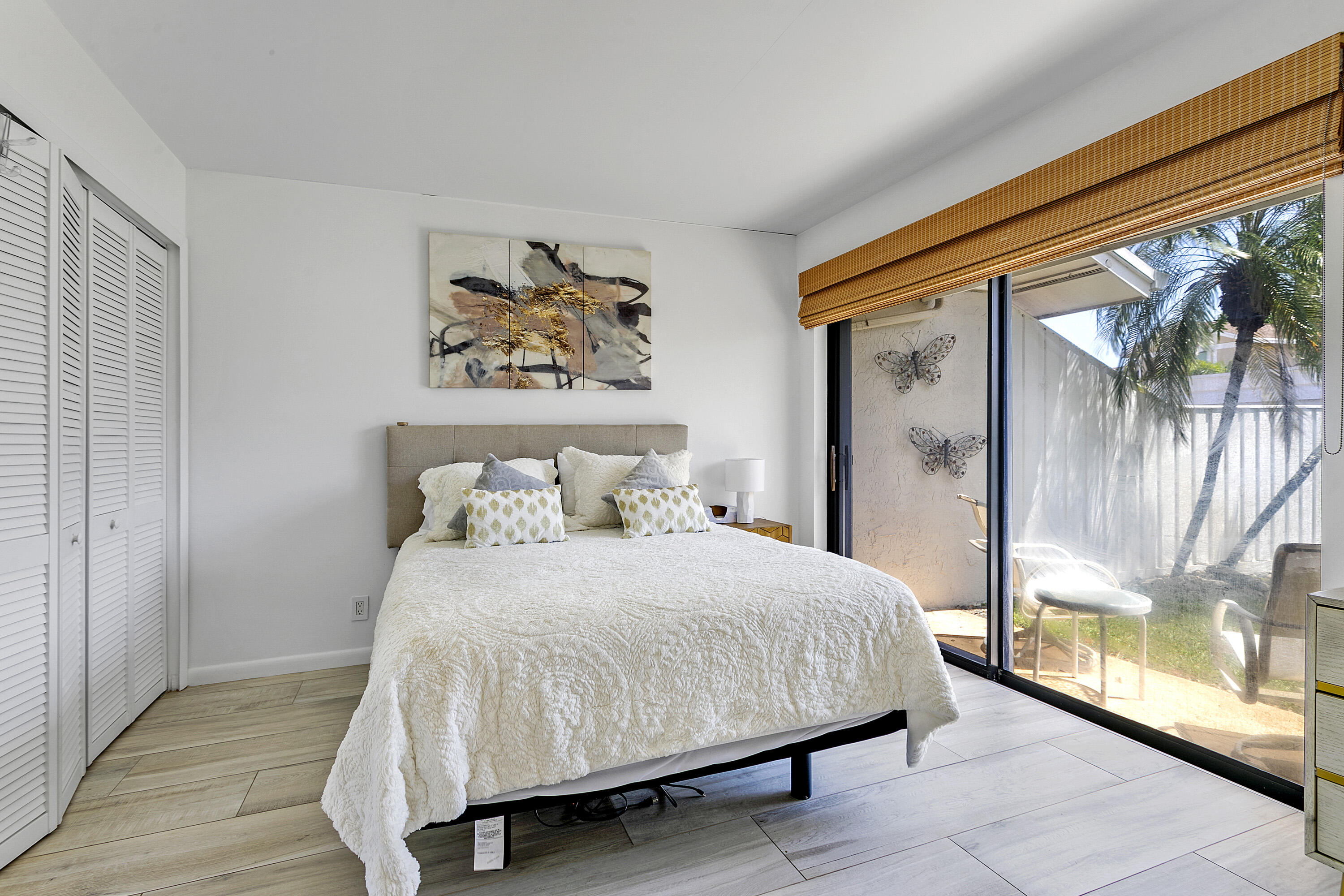 3697 Cape Pointe Circle Jupiter, FL 33477 - Photo 27 of 55 a bedroom with a large bed and a large window