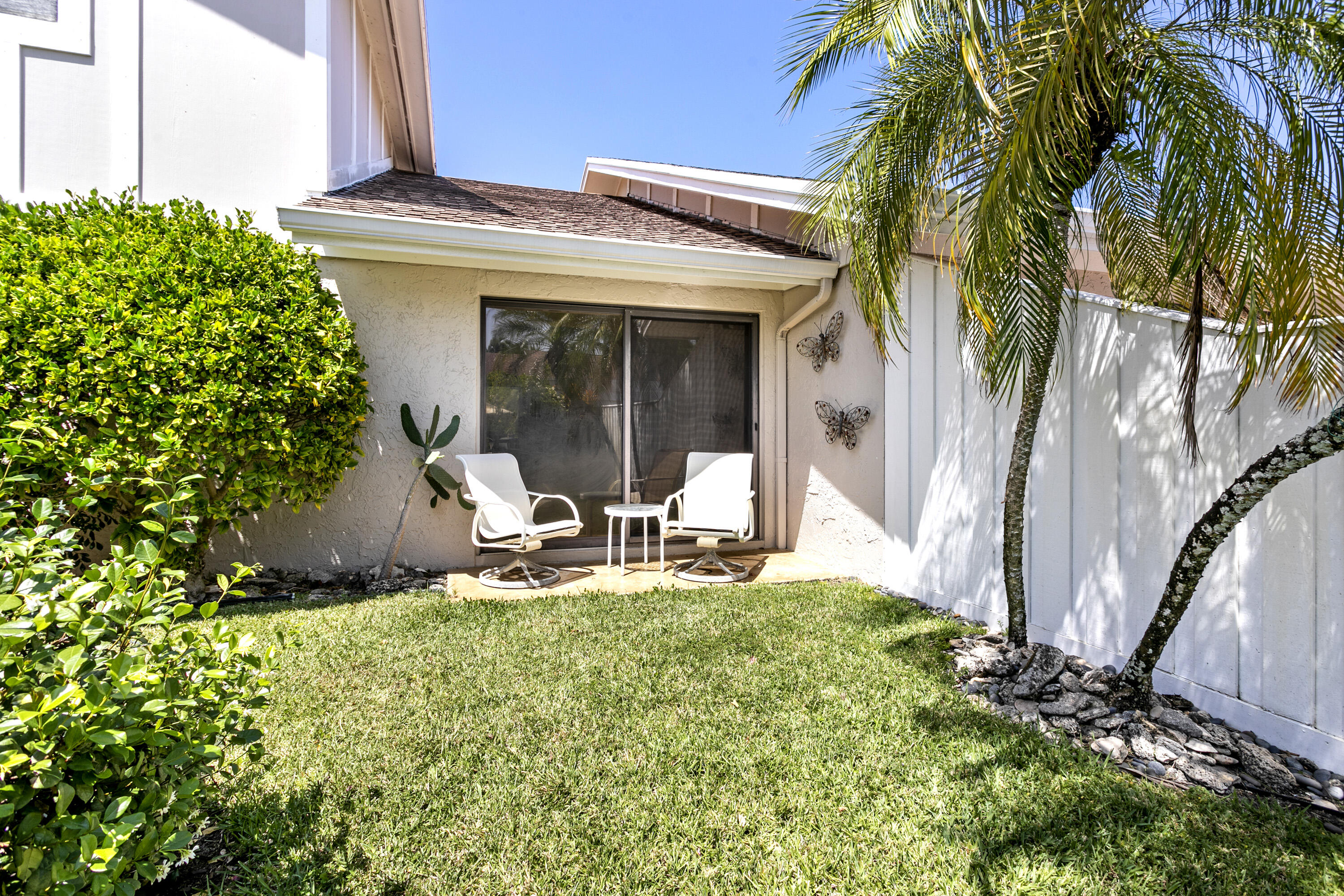 3697 Cape Pointe Circle Jupiter, FL 33477 - Photo 29 of 55 a view of a house with backyard sitting area and garden