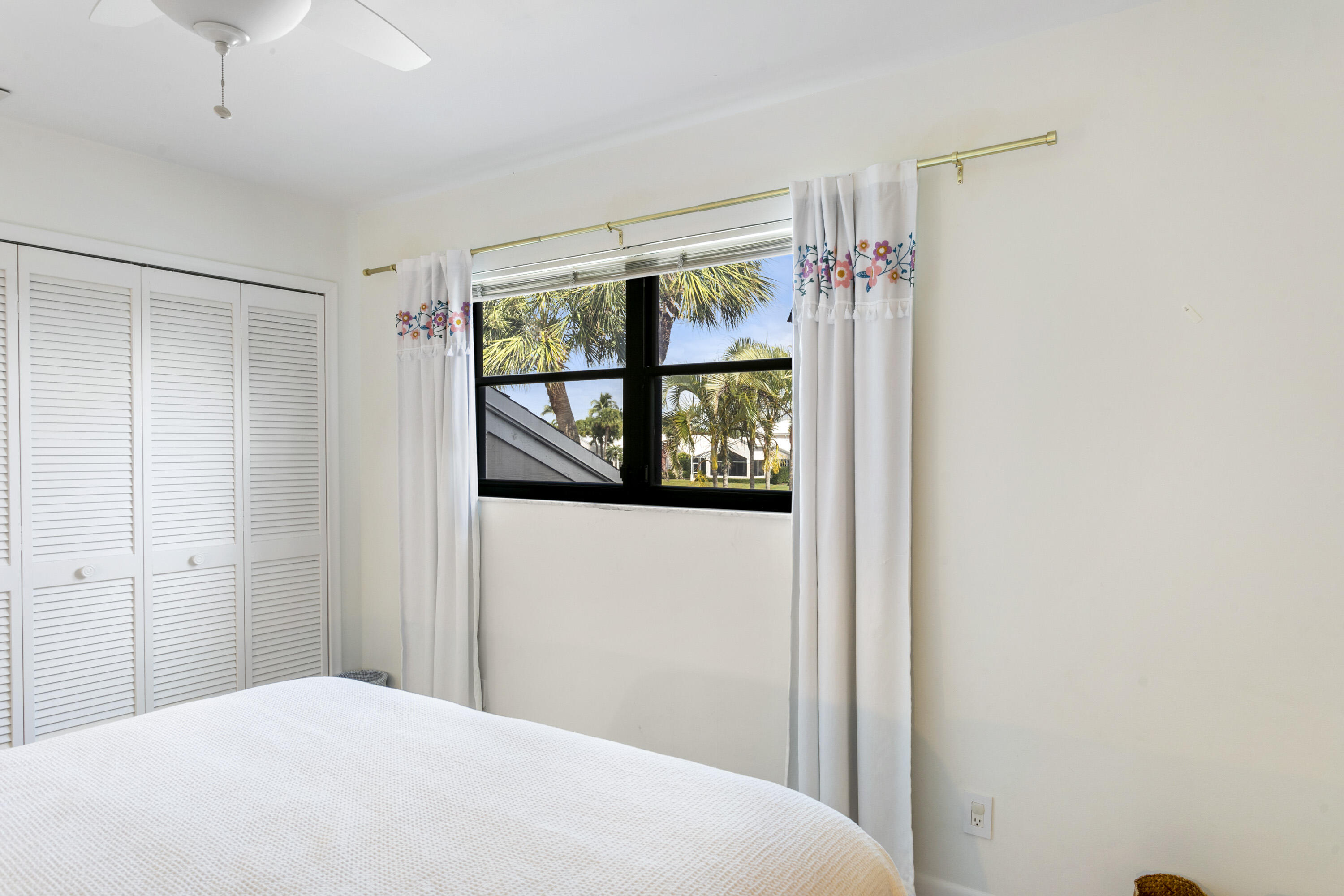 3697 Cape Pointe Circle Jupiter, FL 33477 - Photo 39 of 55 a bedroom with a large window and shower