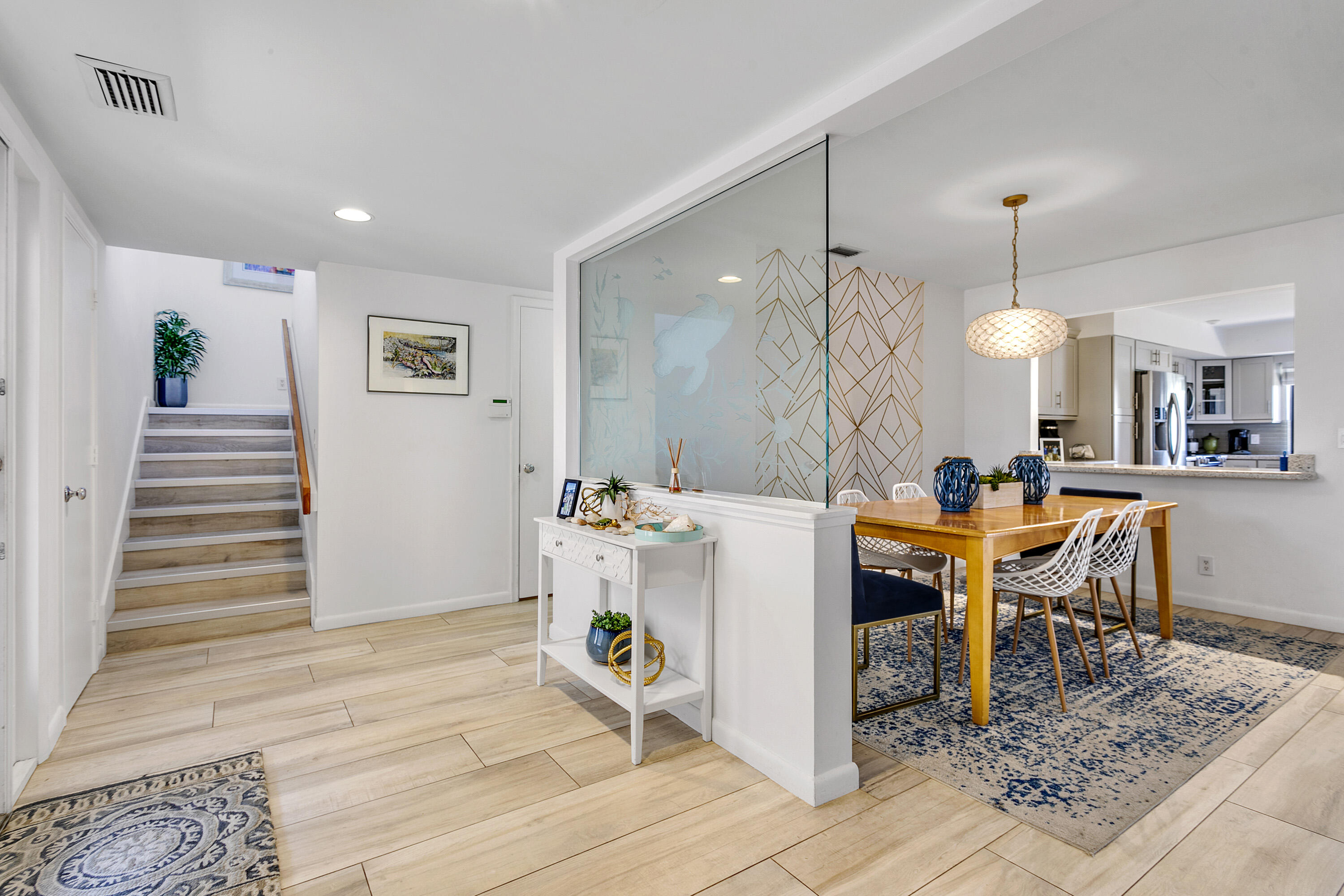 3697 Cape Pointe Circle Jupiter, FL 33477 - Photo 4 of 55 a view of a dining room with furniture and wooden floor