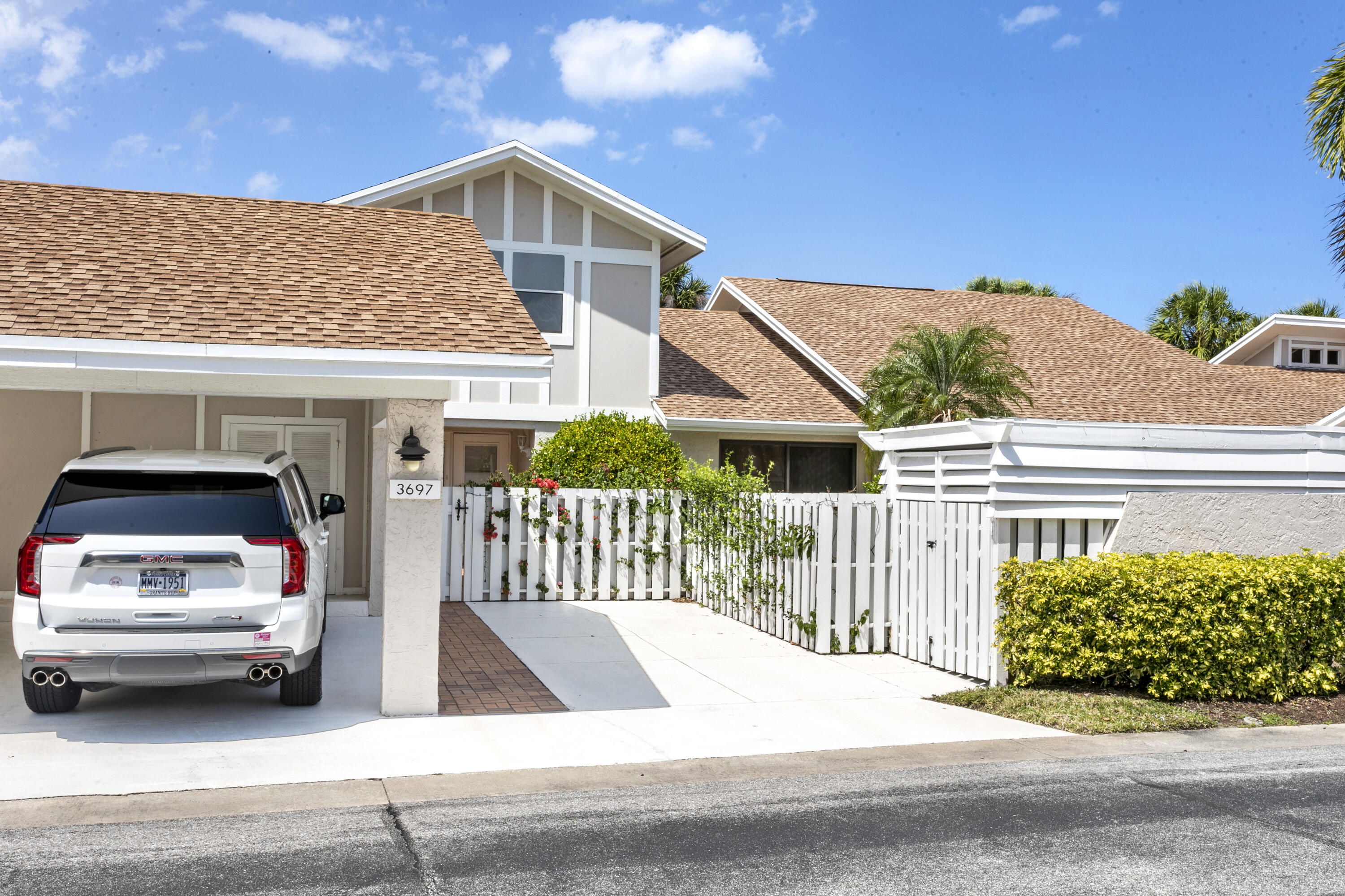 3697 Cape Pointe Circle Jupiter, FL 33477 - Photo 44 of 55 a view of a car parked in front of a house