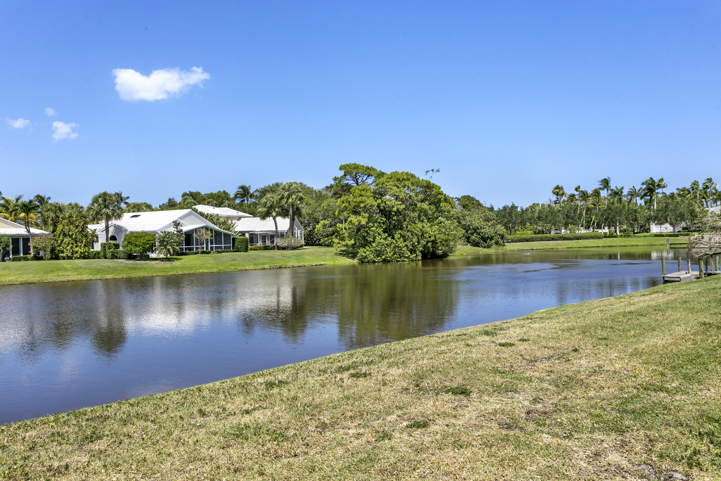 3697 Cape Pointe Circle Jupiter, FL 33477 - Photo 45 of 55 a view of a lake with houses in the back