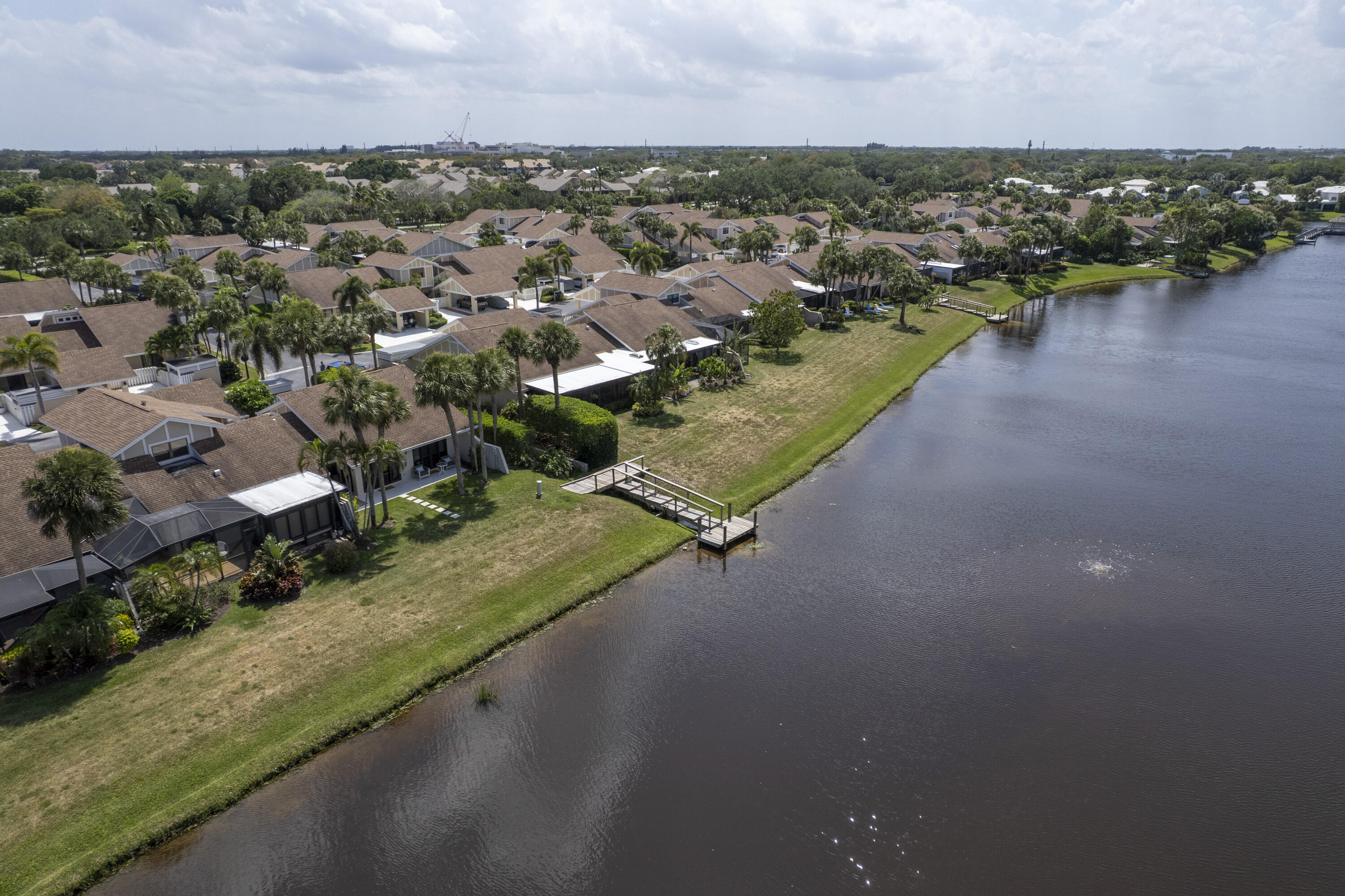 3697 Cape Pointe Circle Jupiter, FL 33477 - Photo 48 of 55 an aerial view of a house with a yard and lake view