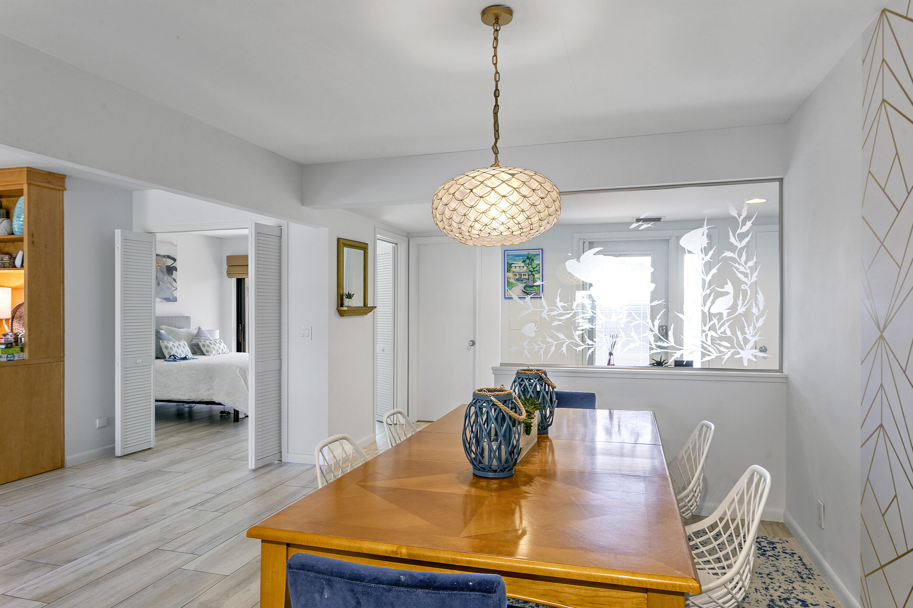 3697 Cape Pointe Circle Jupiter, FL 33477 - Photo 5 of 55 a view of a dining room with furniture a chandelier and wooden floor