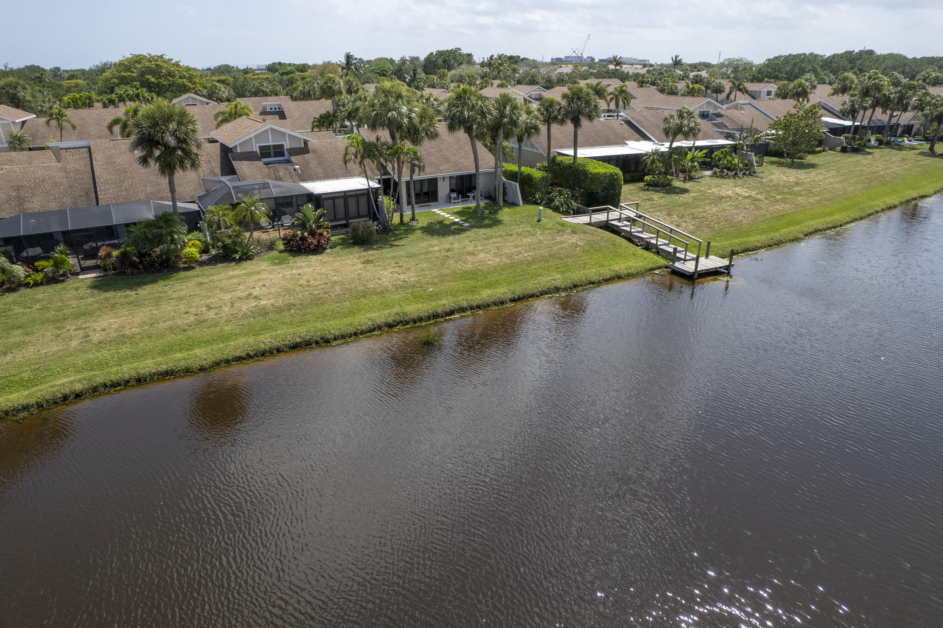 3697 Cape Pointe Circle Jupiter, FL 33477 - Photo 55 of 55 a view of a lake with a yard