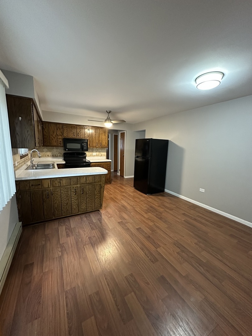 6334 West 65th Street, Unit 2N Chicago, IL 60638 - Photo 3 of 9 a kitchen with stainless steel appliances a refrigerator sink and microwave