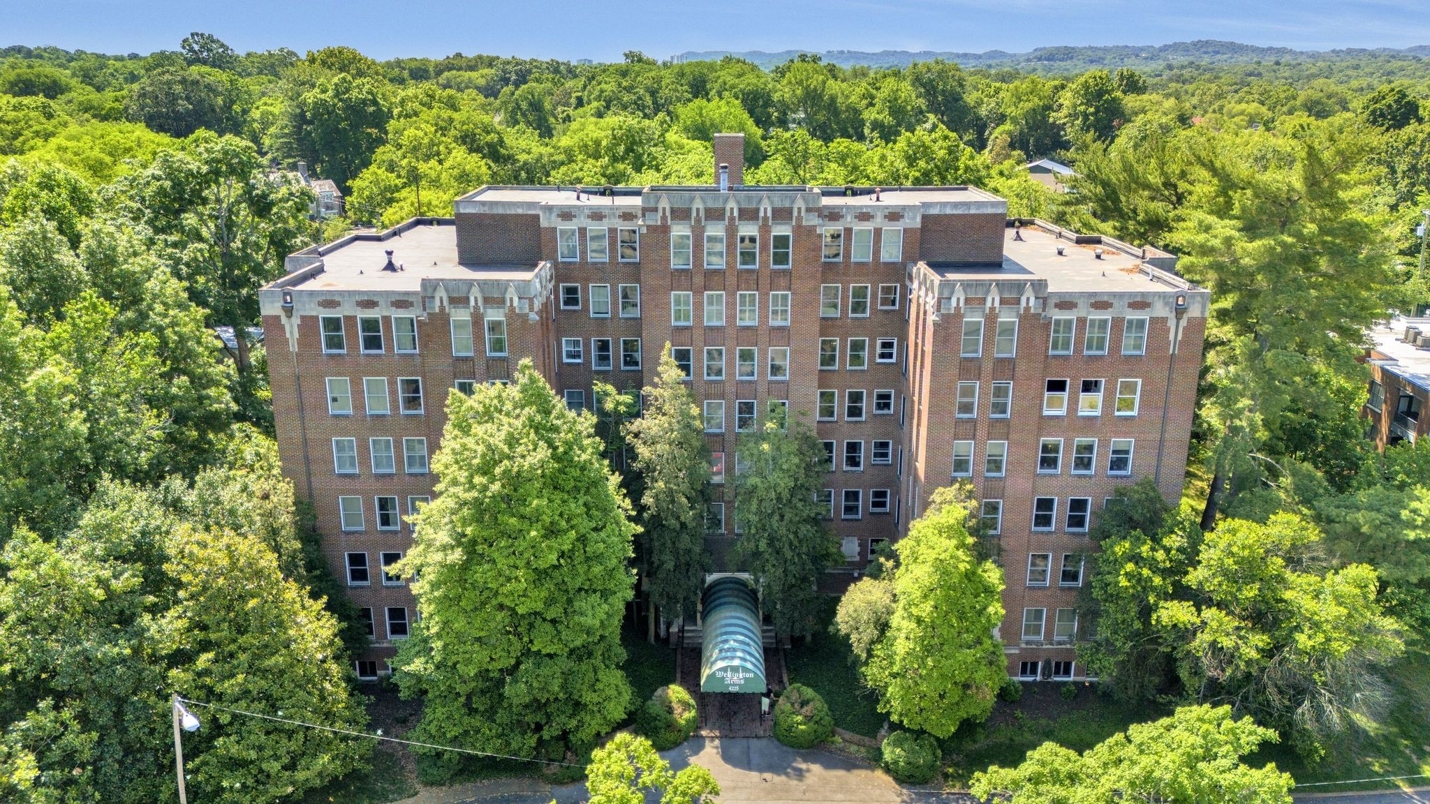4225 Harding Pike, Unit 603 Nashville, TN 37205 - Photo 1 of 59 a front view of a multi story building with a yard