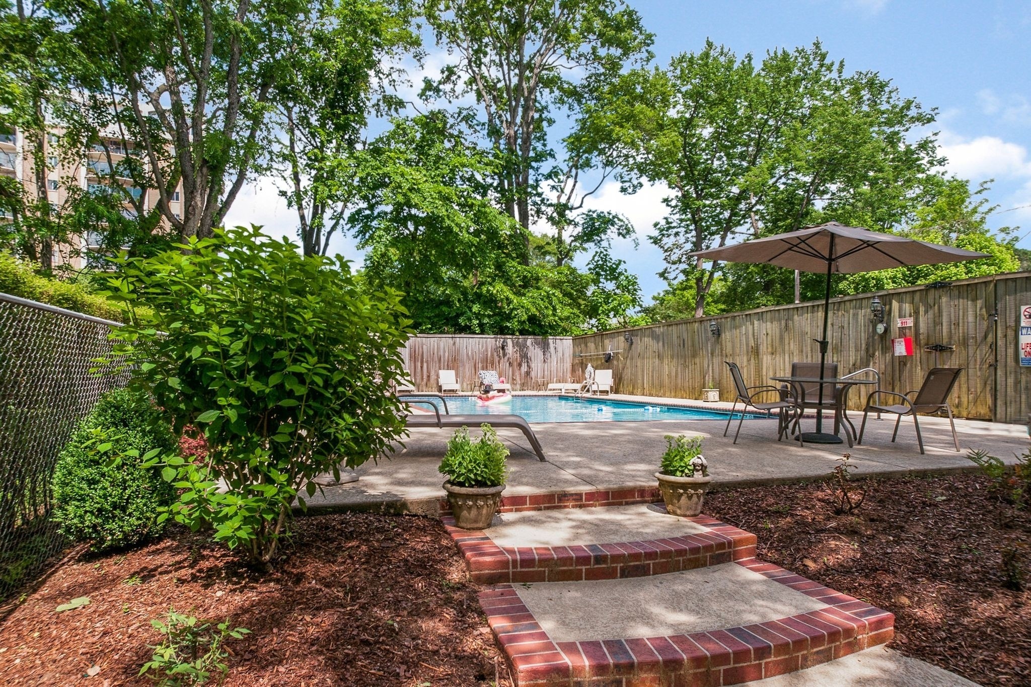 4225 Harding Pike, Unit 603 Nashville, TN 37205 - Photo 44 of 59 a backyard of a house with table and chairs