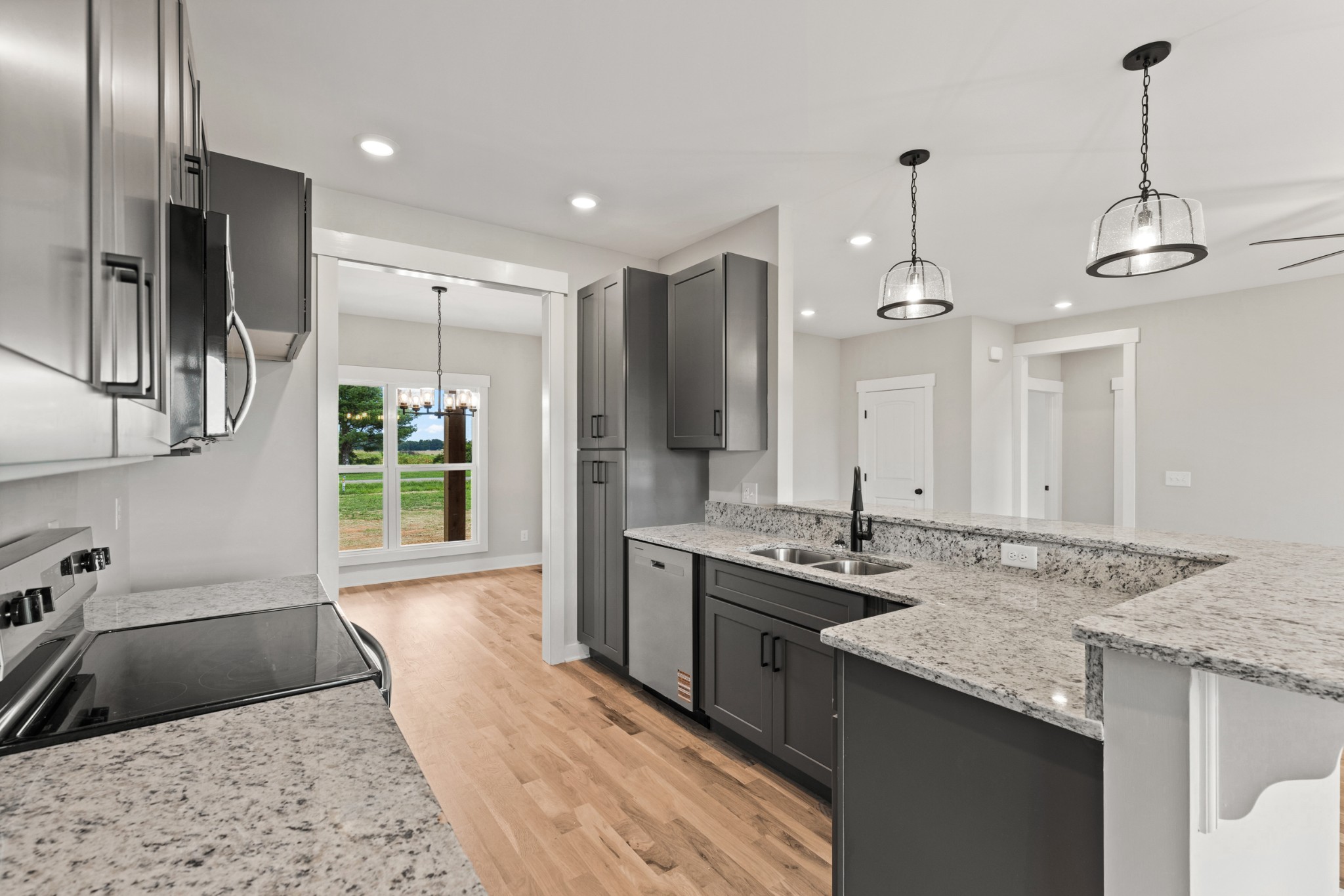 5638 Borthick Road Springfield, TN 37172 - Photo 14 of 43 a kitchen with stainless steel appliances granite countertop a sink a stove and a refrigerator