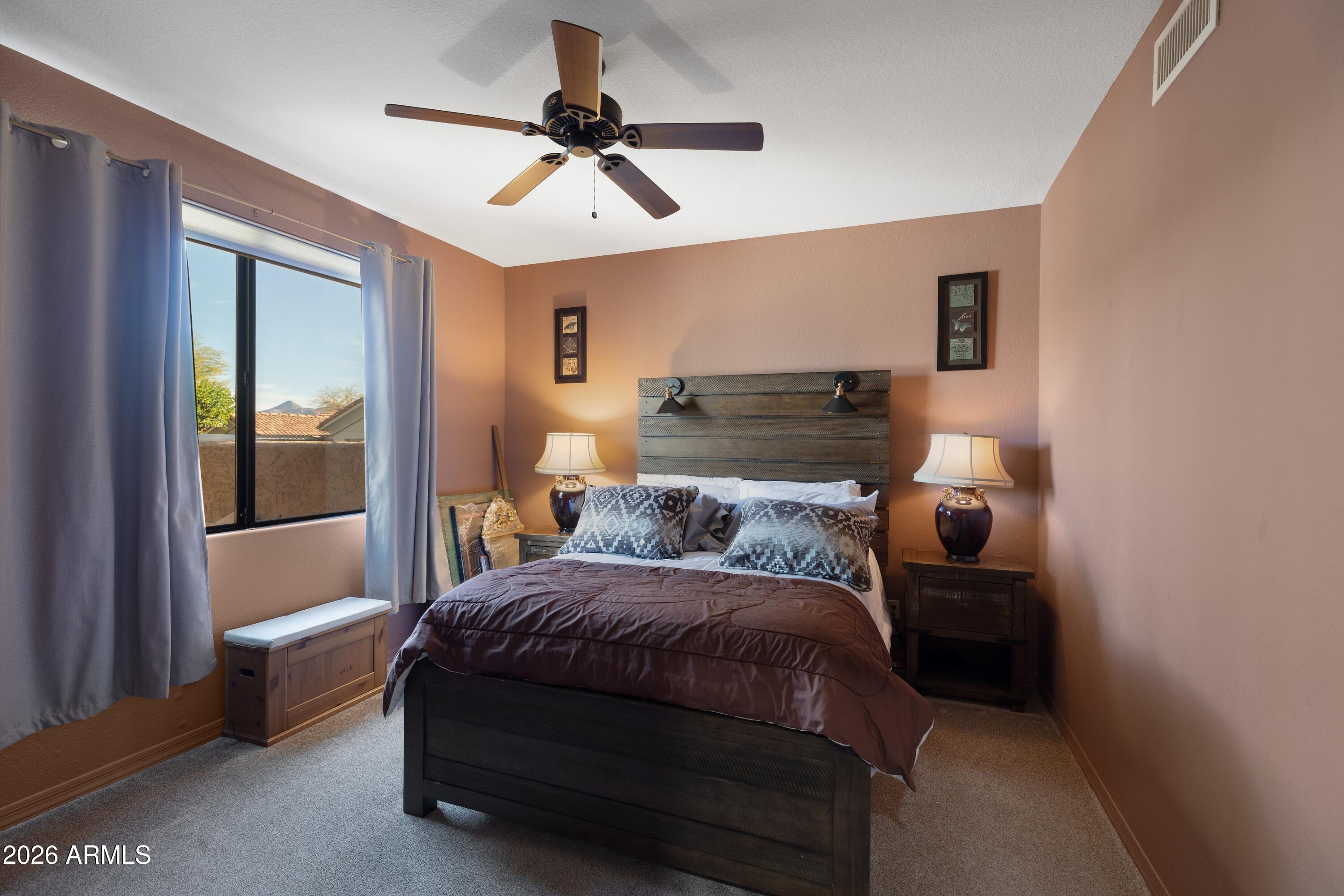 18622 North Tonto Verde Drive Rio Verde, AZ 85263 - Photo 25 of 47 a bedroom with a bed and a chandelier