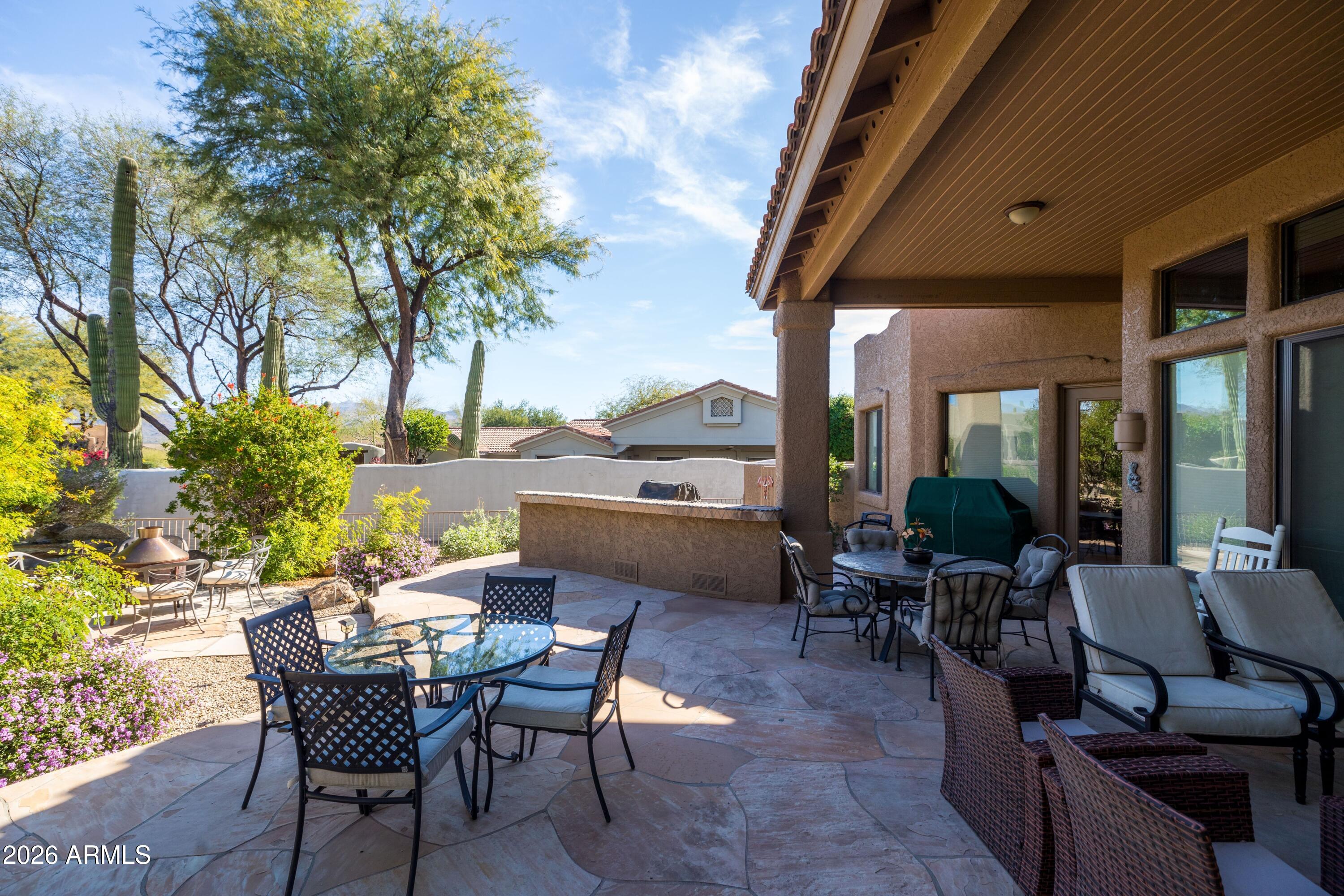 18622 North Tonto Verde Drive Rio Verde, AZ 85263 - Photo 30 of 47 a view of a patio with couches table and chairs and potted plants