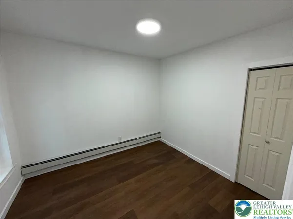 an empty room with wooden floor