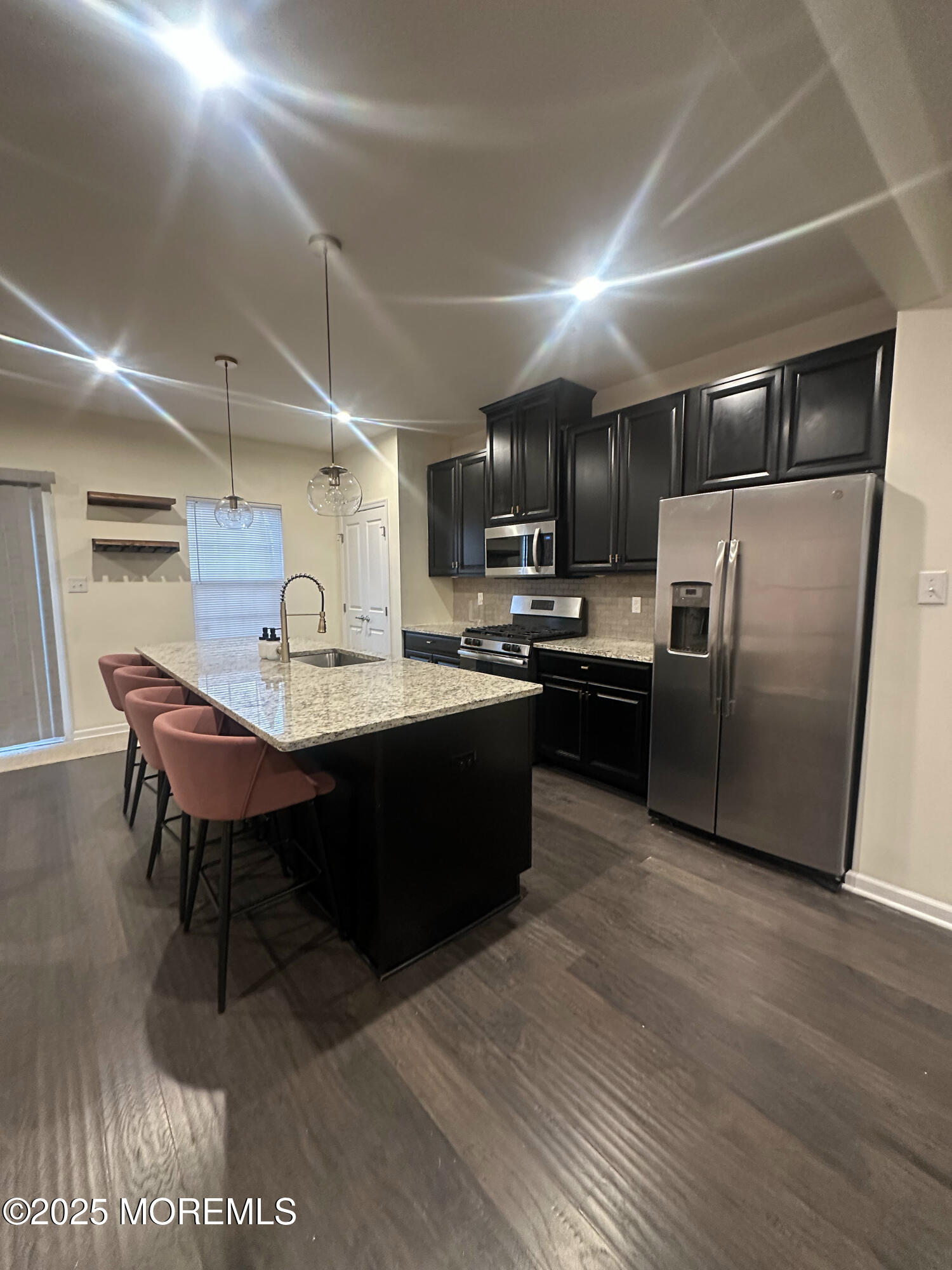 802 Rio Grande Drive, Unit 2002 Toms River, NJ 08755 - Photo 2 of 41 a kitchen with kitchen island a sink counter and chairs