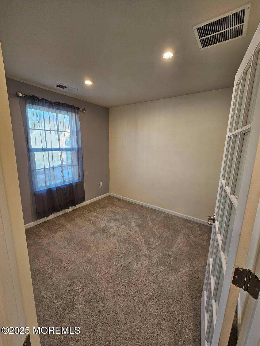 802 Rio Grande Drive, Unit 2002 Toms River, NJ 08755 - Photo 21 of 41 an empty room with windows