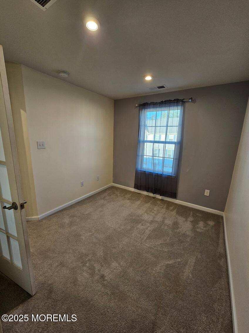 802 Rio Grande Drive, Unit 2002 Toms River, NJ 08755 - Photo 22 of 41 an empty room with a window