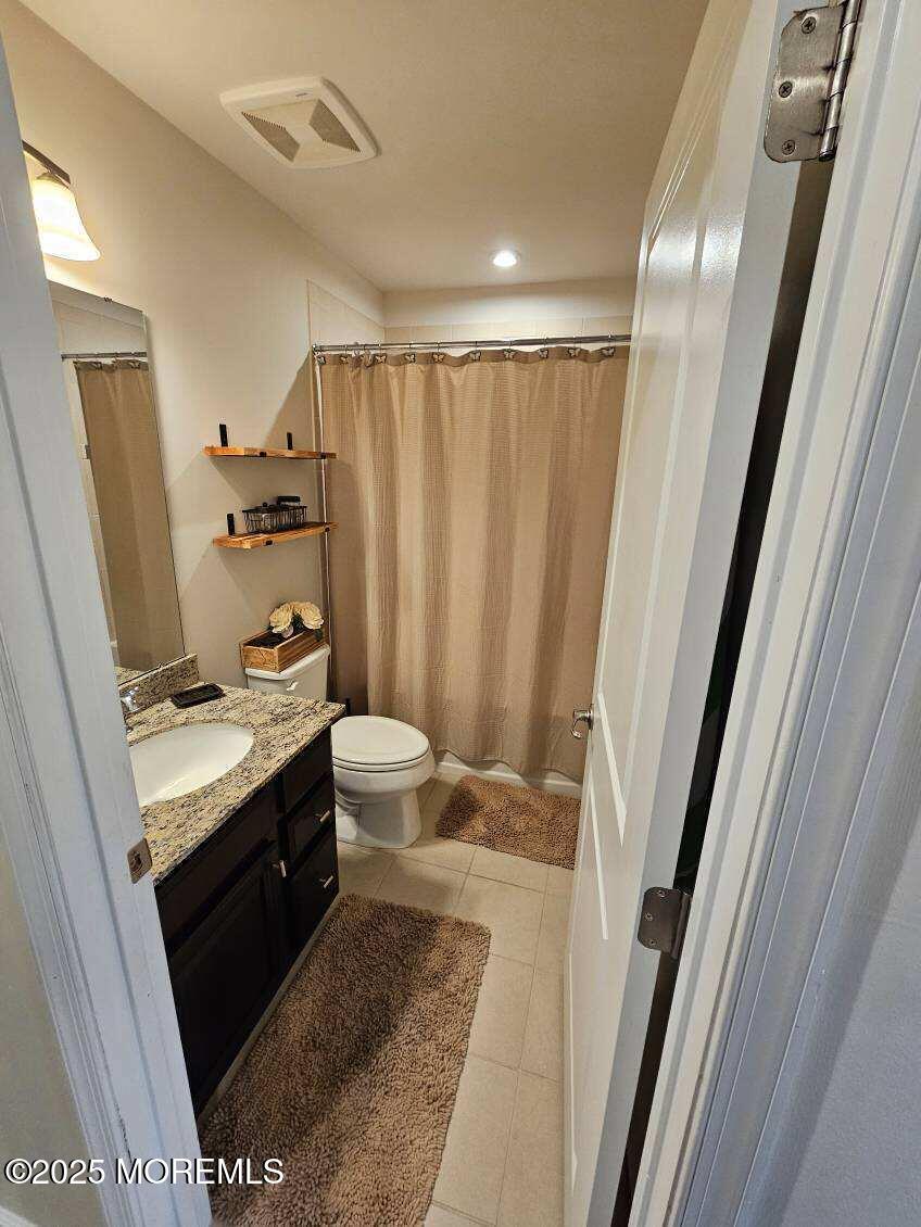 802 Rio Grande Drive, Unit 2002 Toms River, NJ 08755 - Photo 25 of 41 a bathroom with a double vanity sink toilet and shower