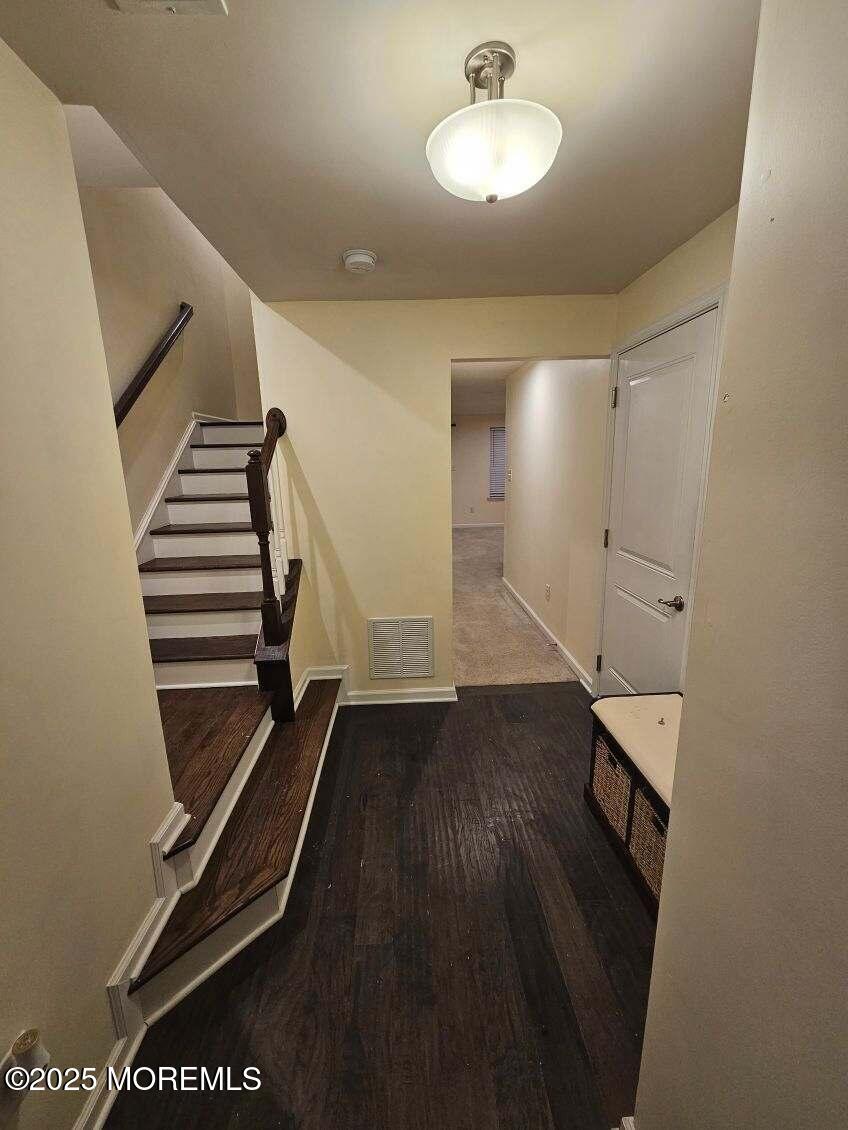 802 Rio Grande Drive, Unit 2002 Toms River, NJ 08755 - Photo 32 of 41 a view of a hallway with wooden floor
