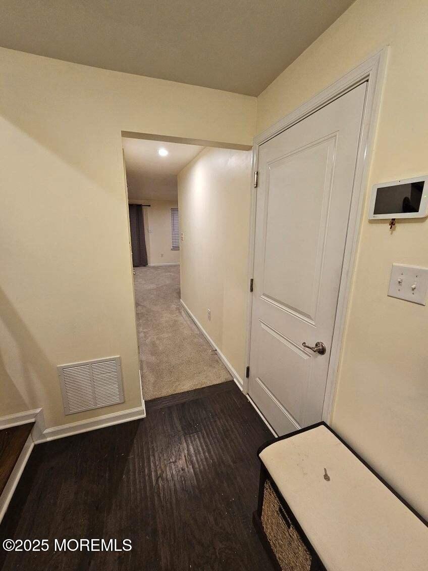 802 Rio Grande Drive, Unit 2002 Toms River, NJ 08755 - Photo 33 of 41 a view of a hallway with wooden floor and closet