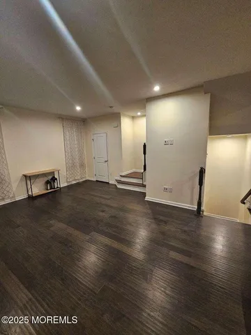 a view of a room with wooden floor