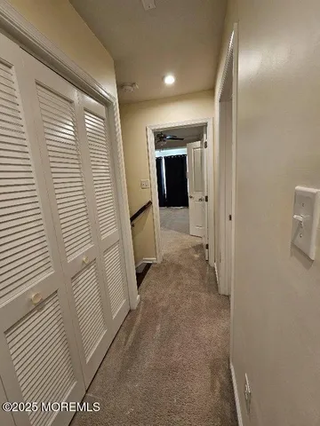 a view of hallway with cabinets