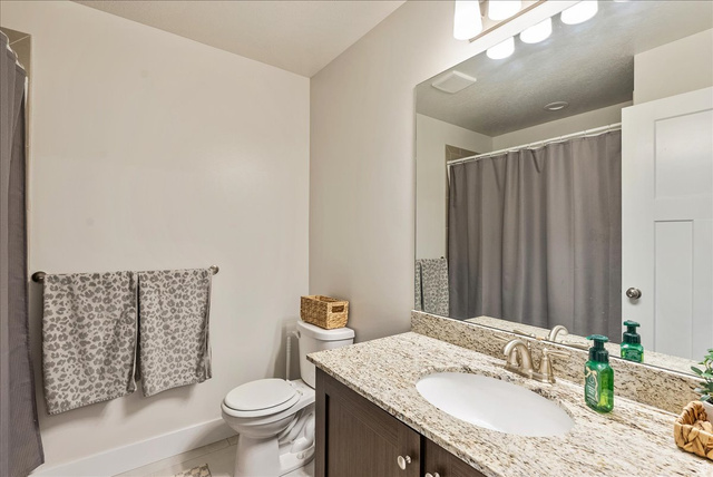 287 North 100th West Morgan, UT 84050 - Photo 22 of 27 Bathroom featuring vanity and a shower with curtain
