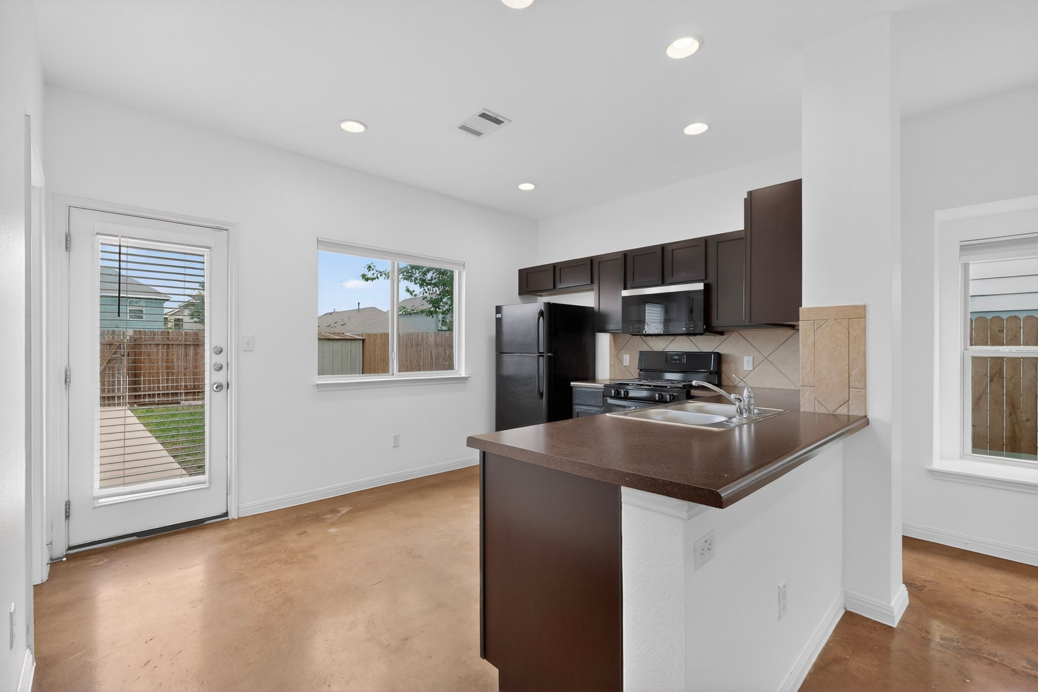 4619 Inicio Lane Austin, TX 78725 - Photo 8 of 32 a kitchen with stainless steel appliances granite countertop a sink stove and refrigerator