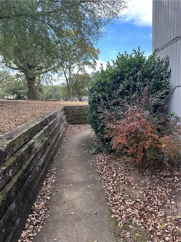 a view of a yard with wooden fence