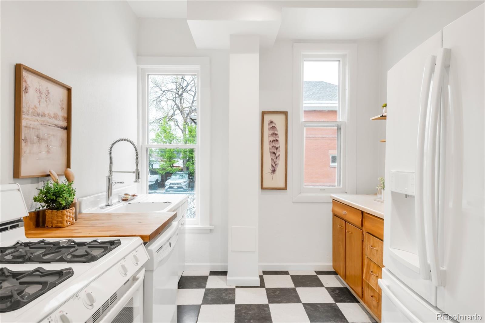 3905 Tejon Street Denver, CO 80211 - Photo 14 of 47 a kitchen with a sink a stove cabinets and a window