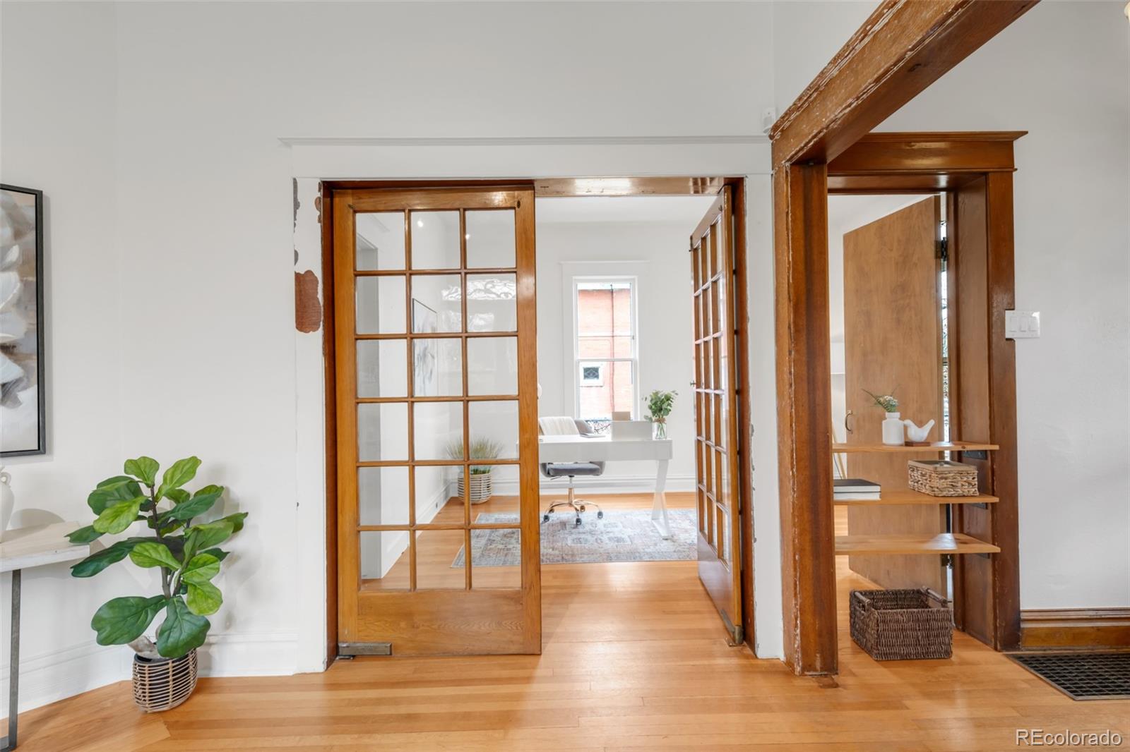3905 Tejon Street Denver, CO 80211 - Photo 16 of 47 a view of a hallway with wooden floor and a potted plant