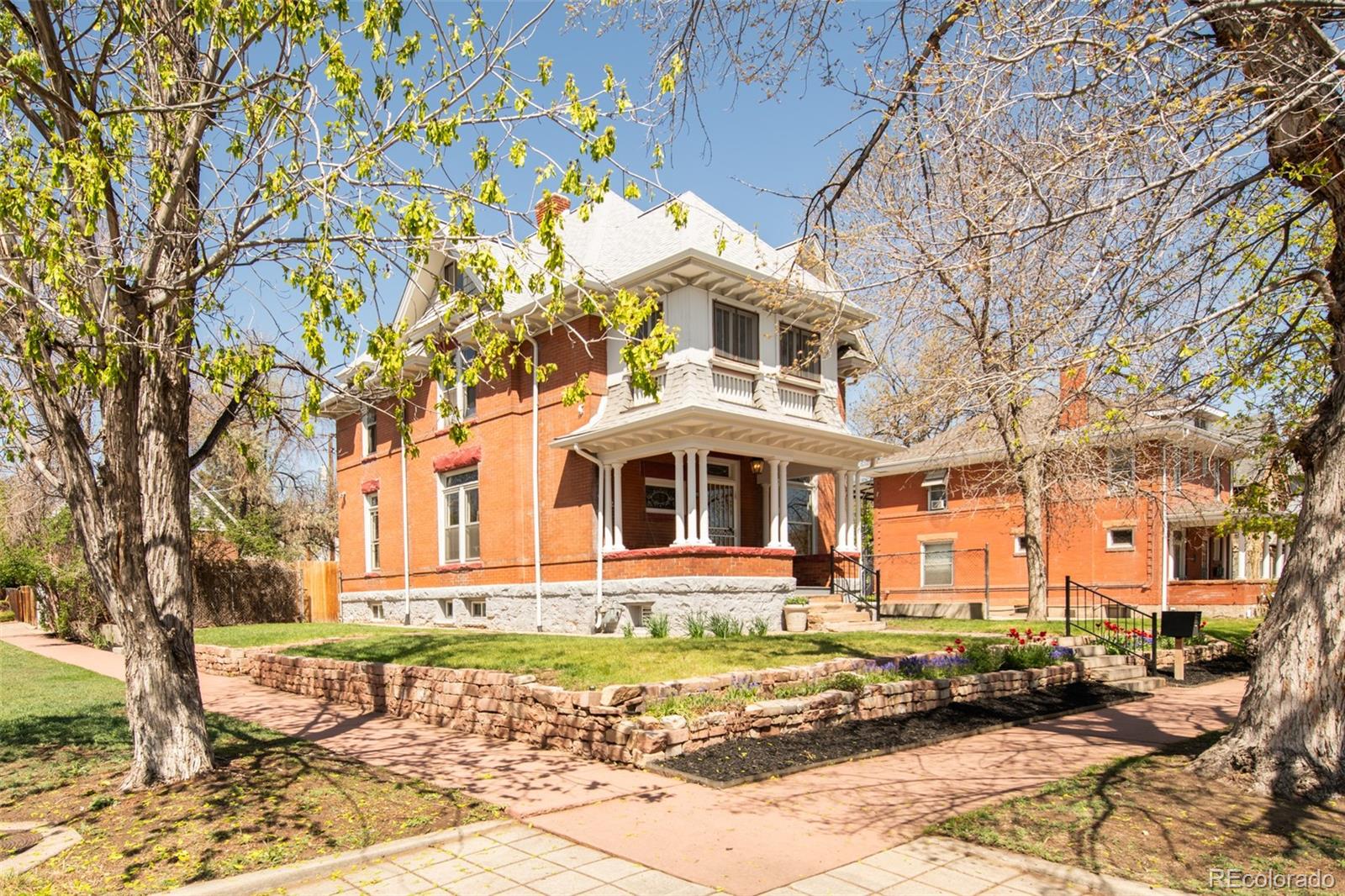 3905 Tejon Street Denver, CO 80211 - Photo 2 of 47 a front view of a house with a yard