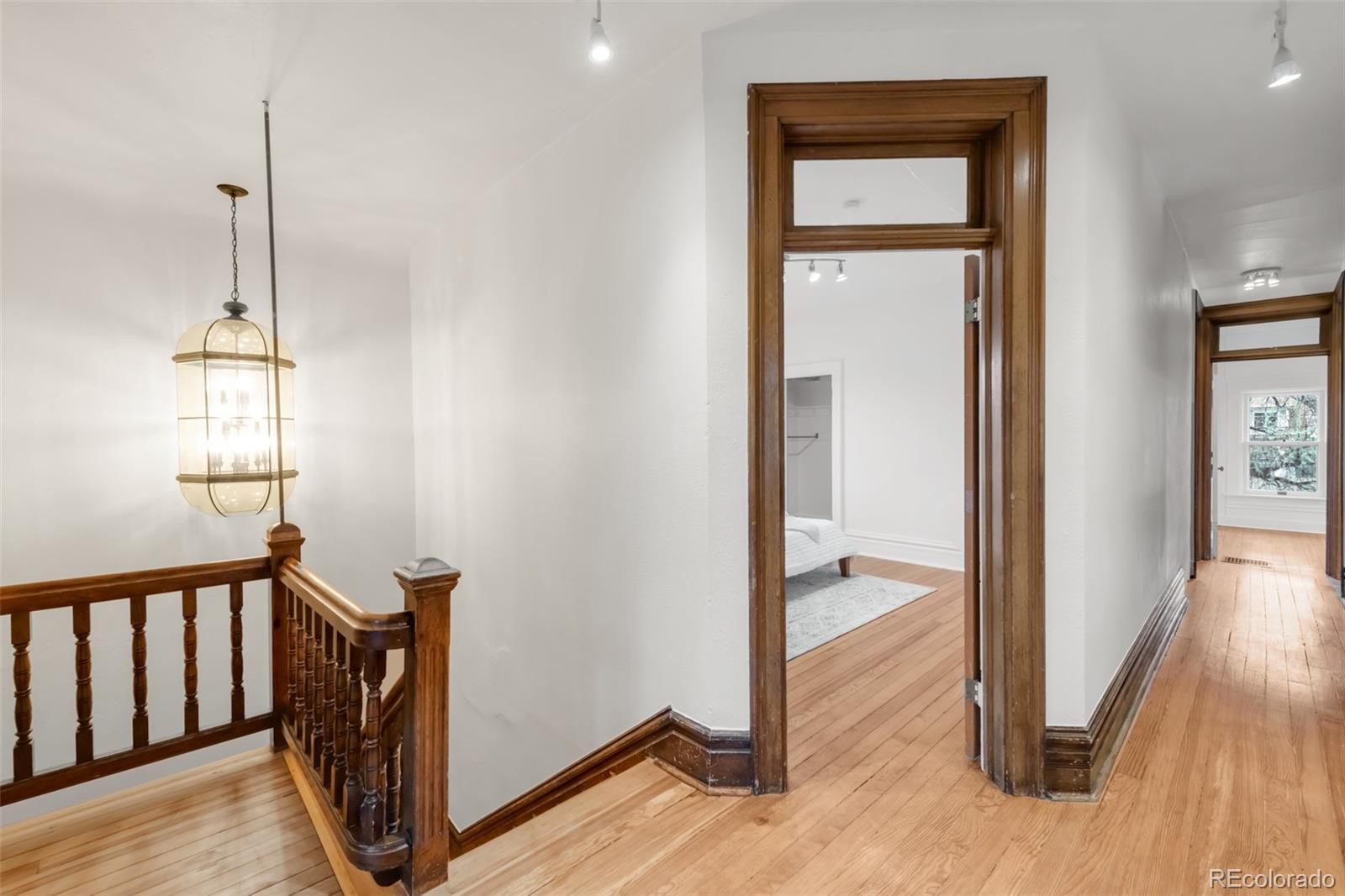 3905 Tejon Street Denver, CO 80211 - Photo 24 of 47 a view of a hallway with wooden floor and stairs
