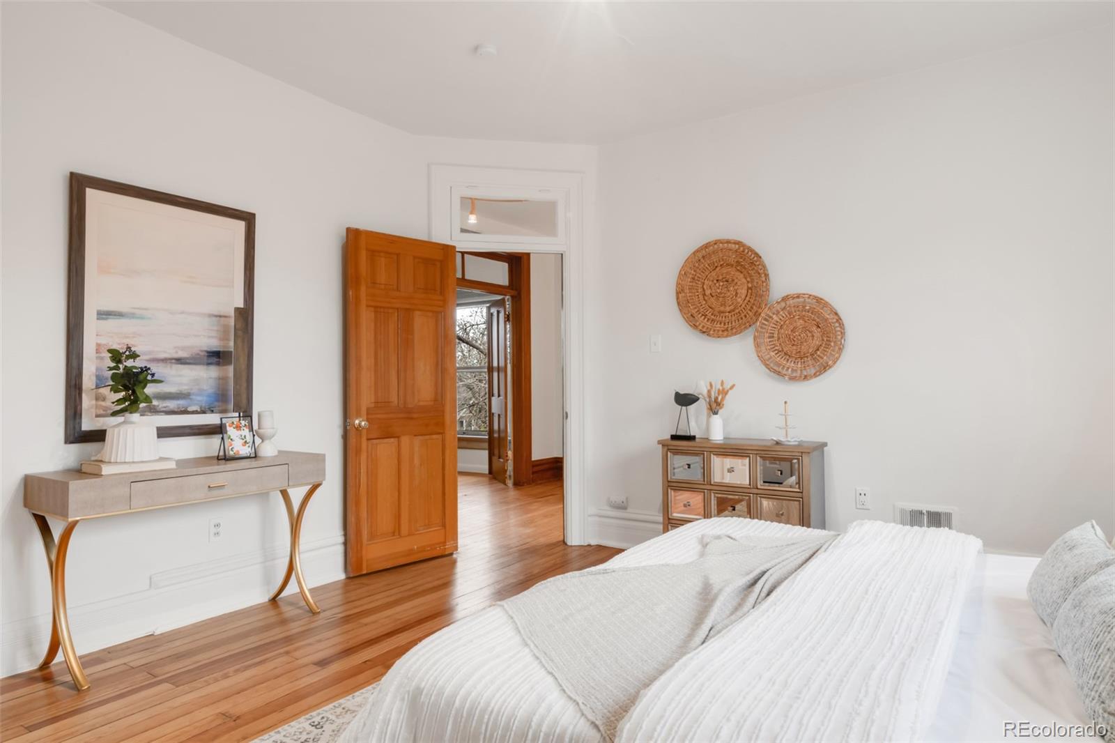 3905 Tejon Street Denver, CO 80211 - Photo 27 of 47 a bedroom with a bed mirror and a window
