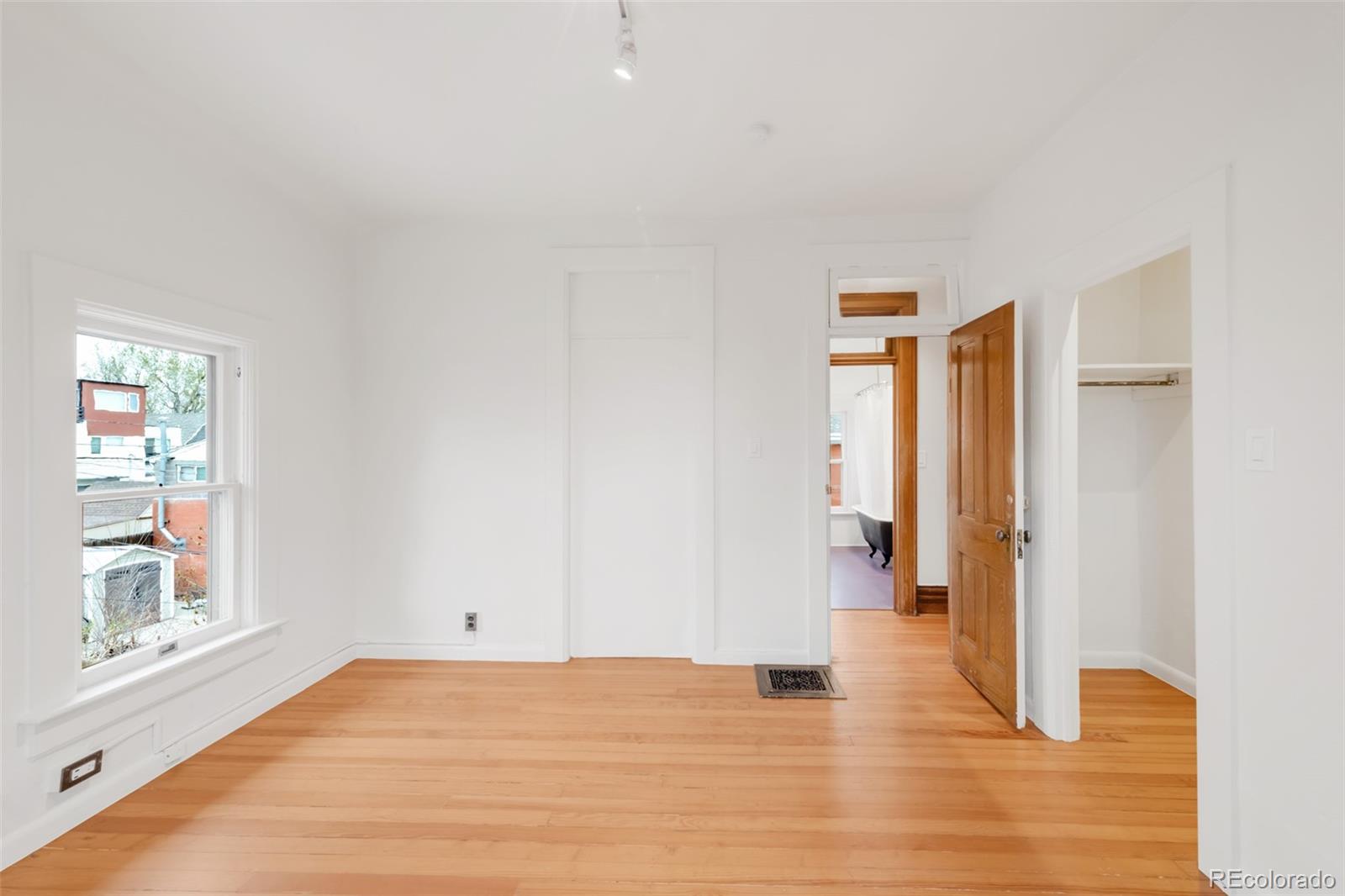 3905 Tejon Street Denver, CO 80211 - Photo 35 of 47 a view of an empty room with wooden floor and a window