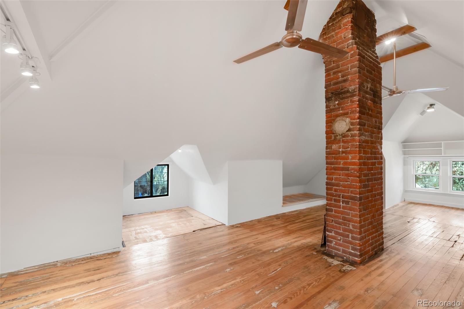 3905 Tejon Street Denver, CO 80211 - Photo 37 of 47 a view of an empty room with wooden floor and a window