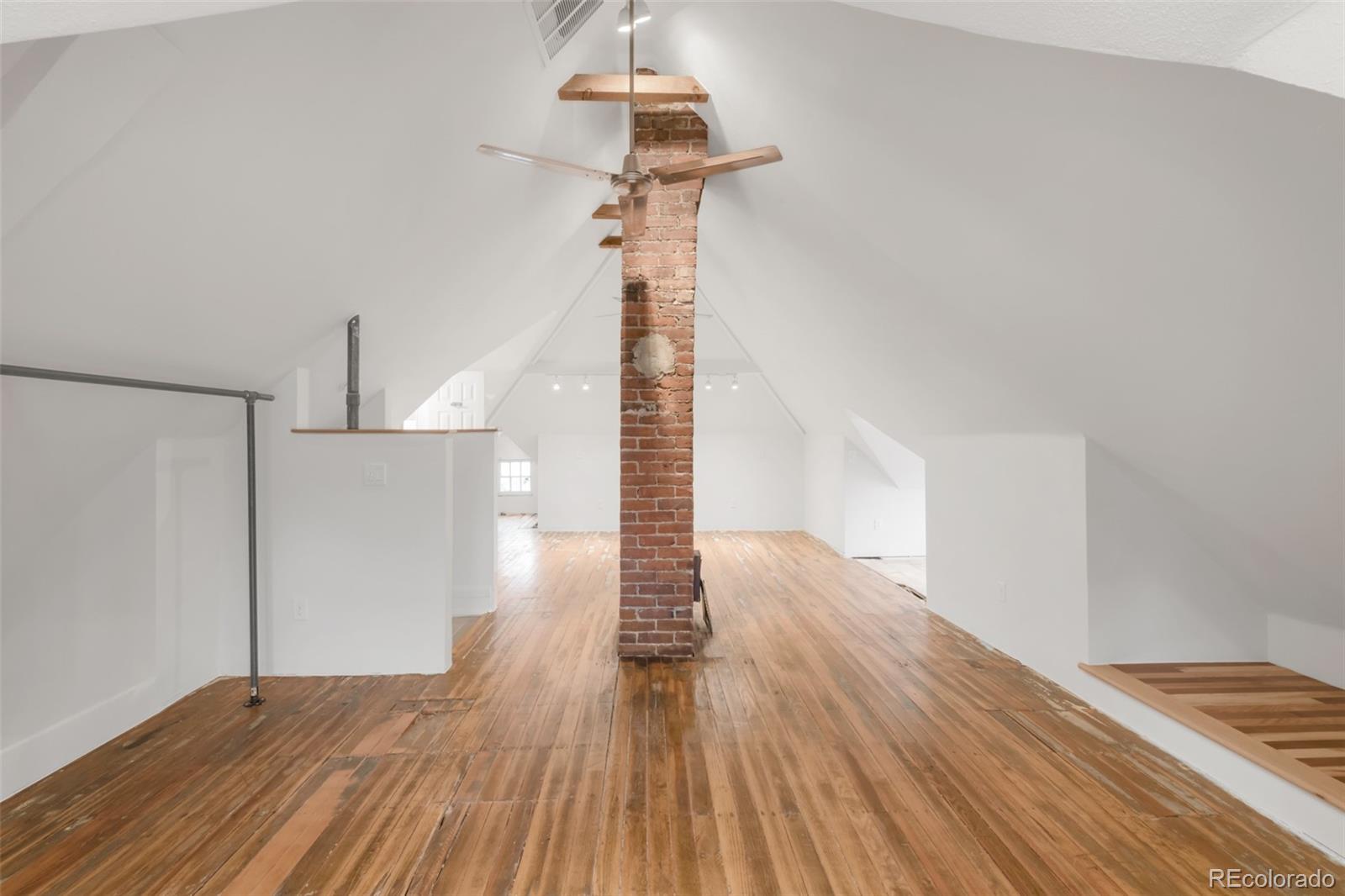 3905 Tejon Street Denver, CO 80211 - Photo 38 of 47 a view of empty room with stairs and wooden floor