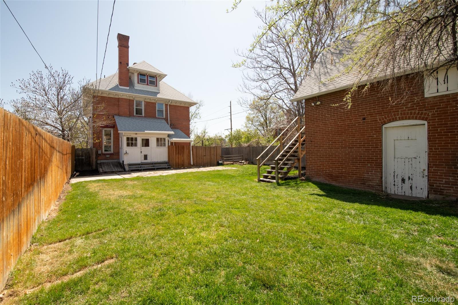 3905 Tejon Street Denver, CO 80211 - Photo 45 of 47 a front view of a house with a yard